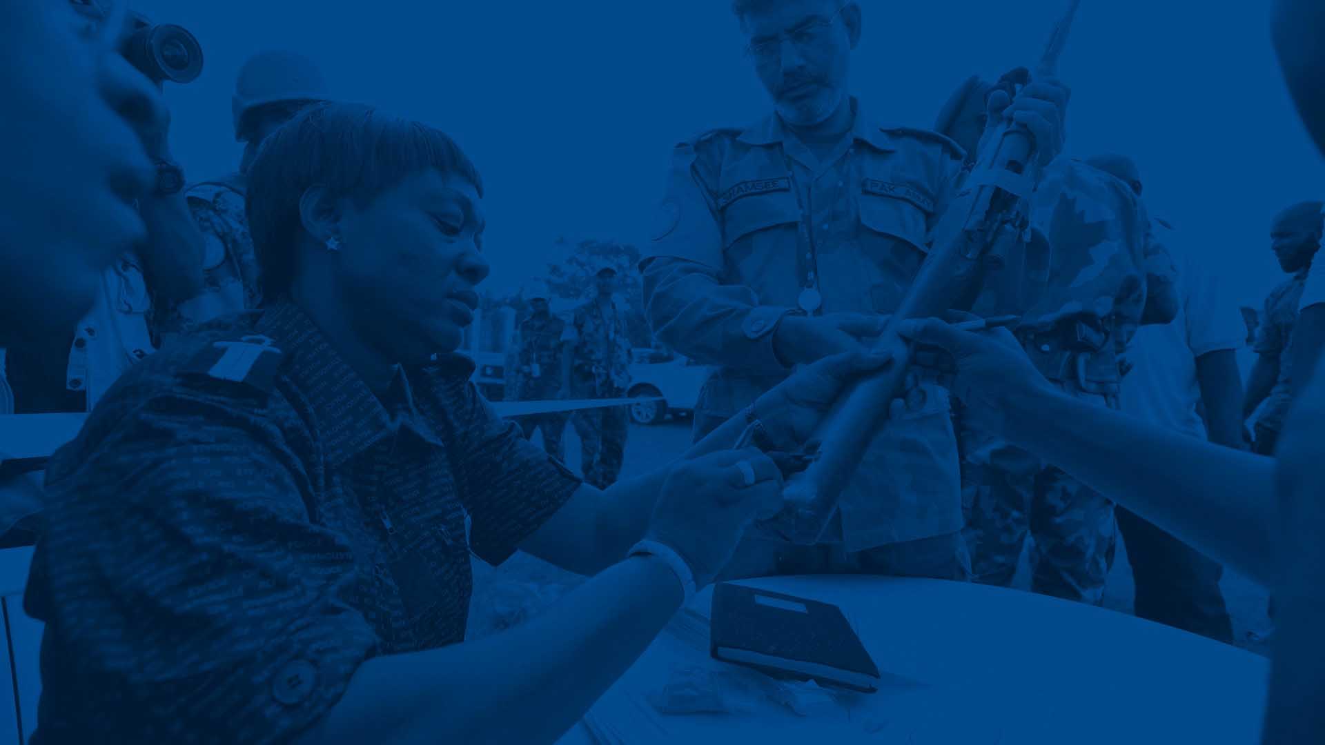 A female soldier checks a gun as part of a weapons and ammunition management exercise