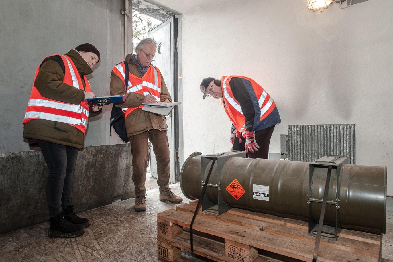 Inspectors examine a bunker and its contents during the Menzingen verification experiment.