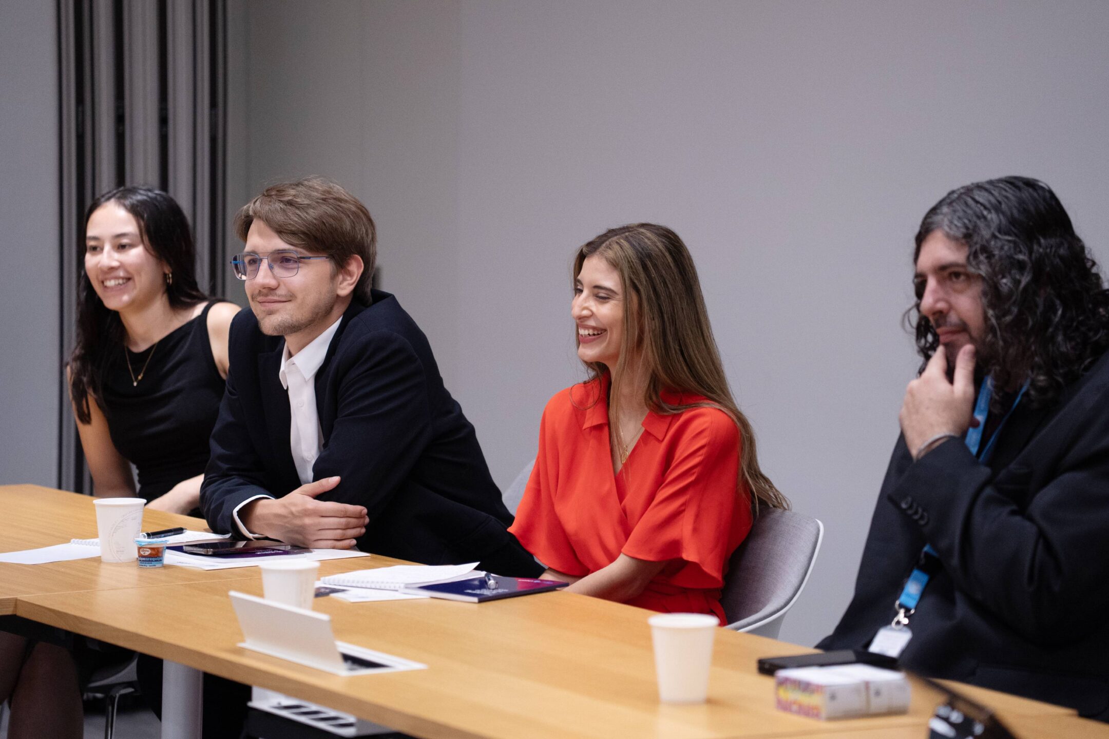 UNIDIR Space Security Research Fellows and participants seated together during a reception.